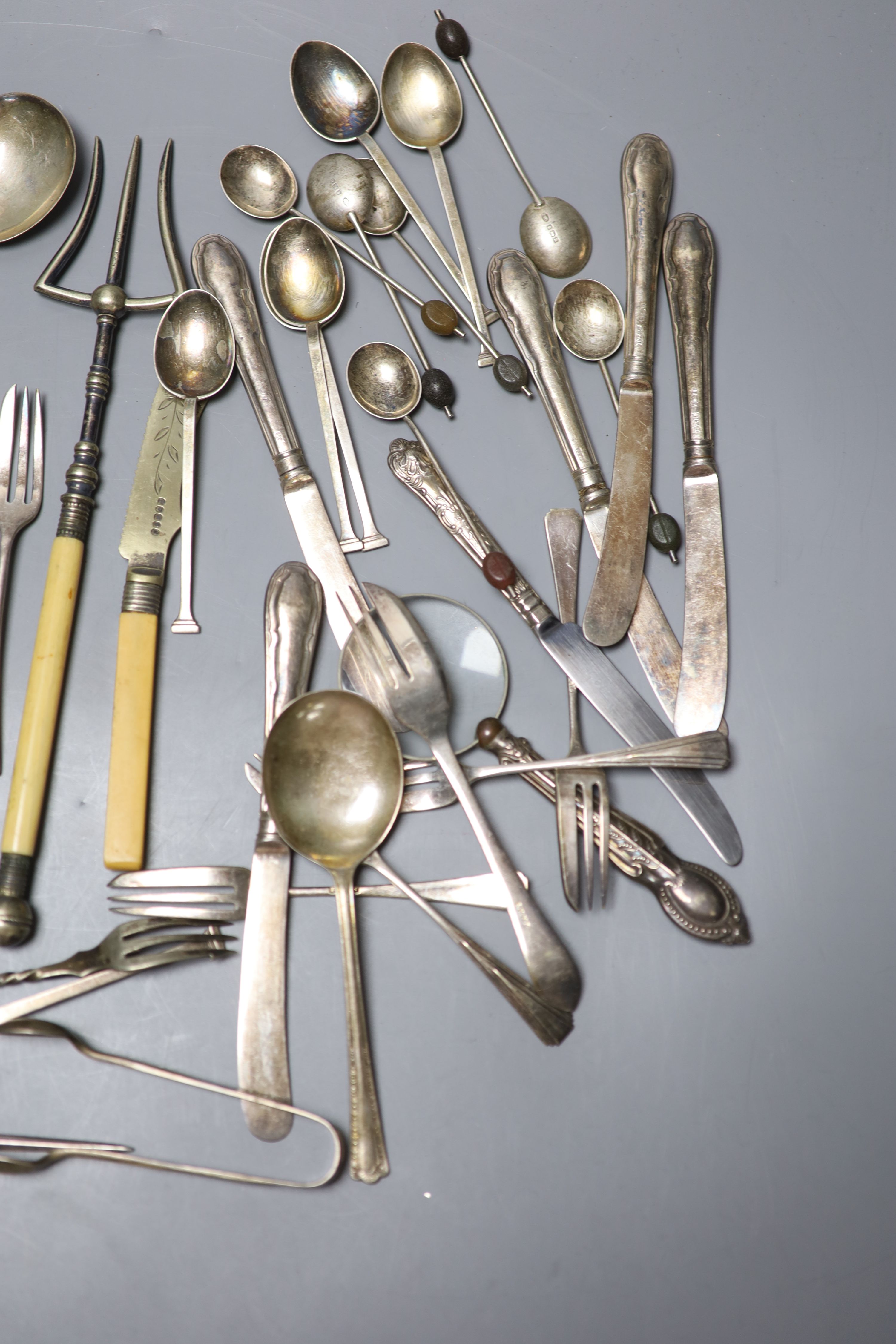 Two sets of silver spoons including bean end coffee spoons, six silver handled tea knives and a silver handled magnifyer etc.